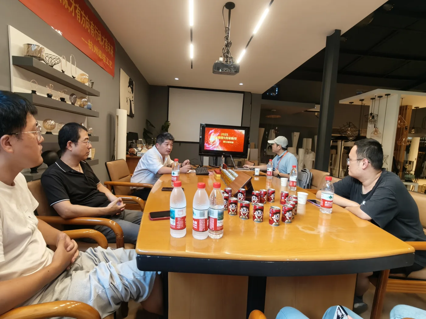 Gathered around the showroom table · August 2025 archive